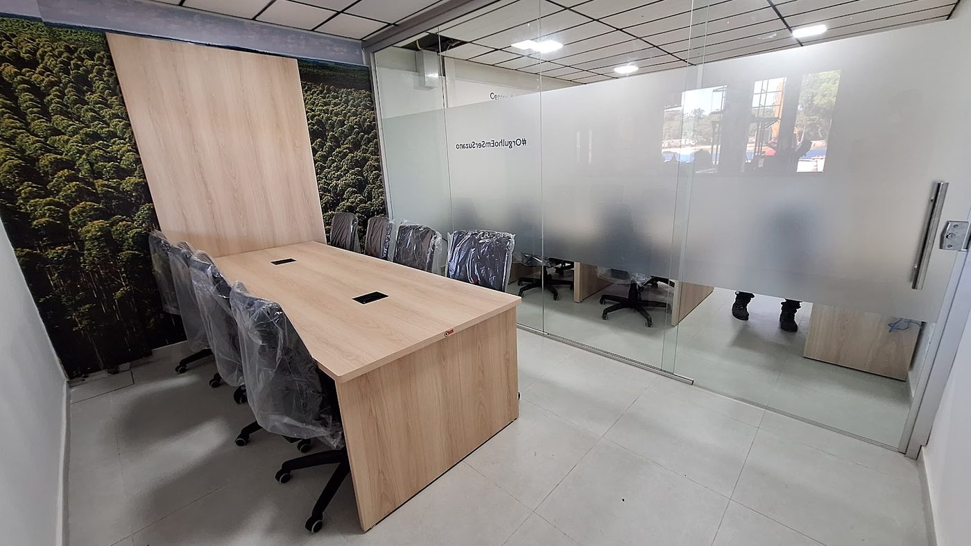 Sala de reuniões com mesa planejada em madeira clara para escritório corporativo